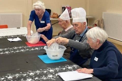 Members of the club partake in a cooking activity.