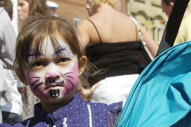 A youngster with a painted face.