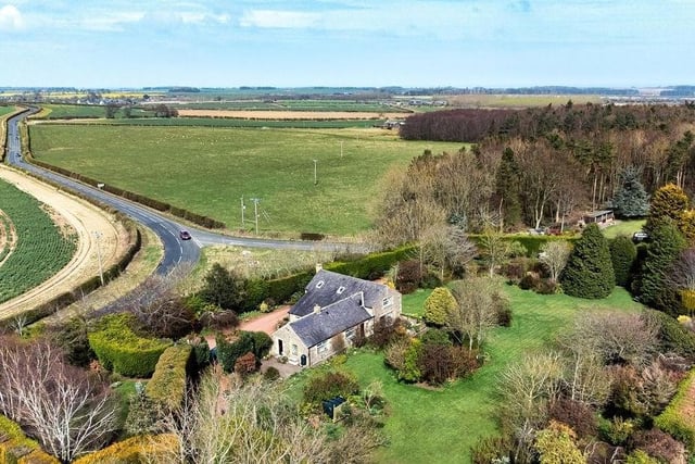 It enjoys enviable privacy set within 1.328 acres of stunning private gardens.