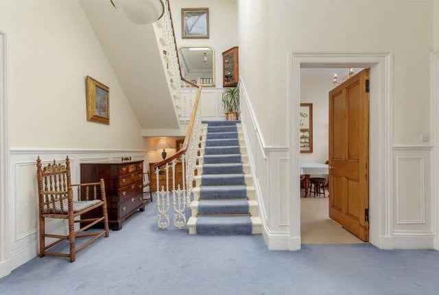 The hallway features an impressive central staircase, which is crowned by a cupola and flooded with light