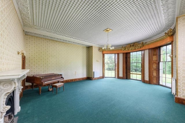 A piano can be seen in the corner of the former music room.