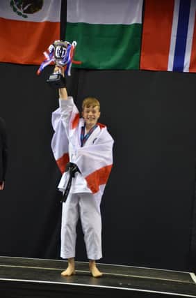 Top of the world ... Denny Shy celebrates his win in the Cadet class at the World Shotokan Championships in Liverpool.
