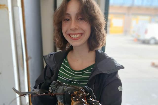 Maria Sutton measuring lobsters.