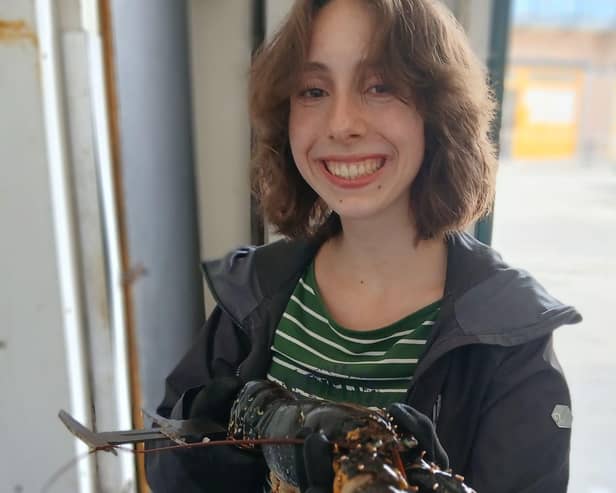 Maria Sutton measuring lobsters.