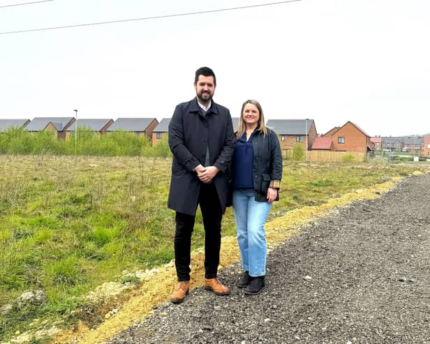Martin Thrumble of Persimmon North East and estate resident Julia Dowd on the new footpath. (Photo by LDRS)