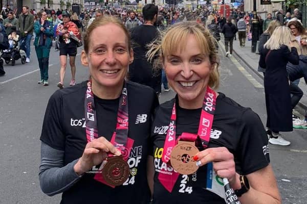 Jane Kirby and Anna Wright show off their London Marathon medals.