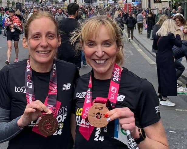 Jane Kirby and Anna Wright show off their London Marathon medals.