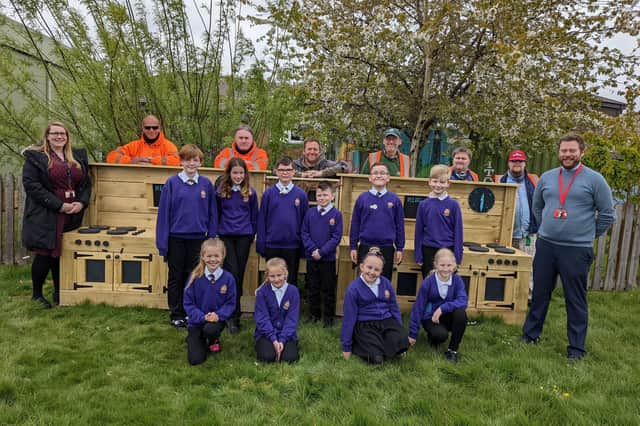 Service users from Blyth Star Enterprises’ woodwork department with staff and pupils at NCEA Thomas Bewick C of E Primary School.