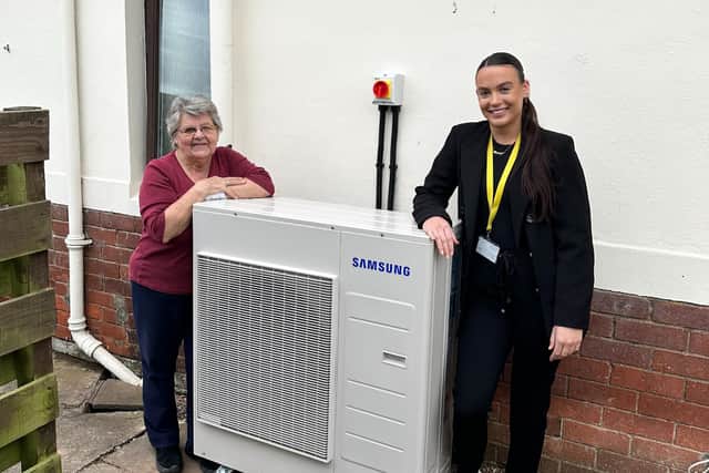 Tenant Edna Smith and Bernicia environmental sustainability advisor Poppy Atterton, outside Edna’s home in Norham with a new air source heat pump.