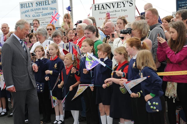 HRH Prince Charles talks to Seahouses First School pupils and admires their home made flags.