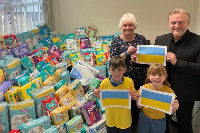 Town Mayor Loraine De Simone, Councillor Wayne Daley, Elijah and Emelia with some of the items collected at Burnside Primary School in Cramlington.