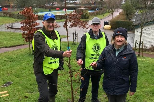 Morpeth Lions Chris Offord and Les Brindley with Frances Povey of Northumberland County Council at the tree planting in Carlisle Park.