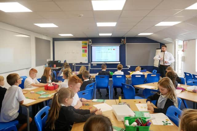 A teacher and pupils in one of Stobhillgate First School's classrooms.