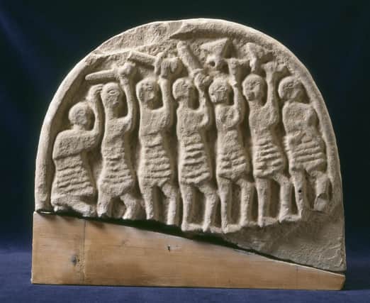 A 9th century viking grave marker, with seven warriors carved into the surface.