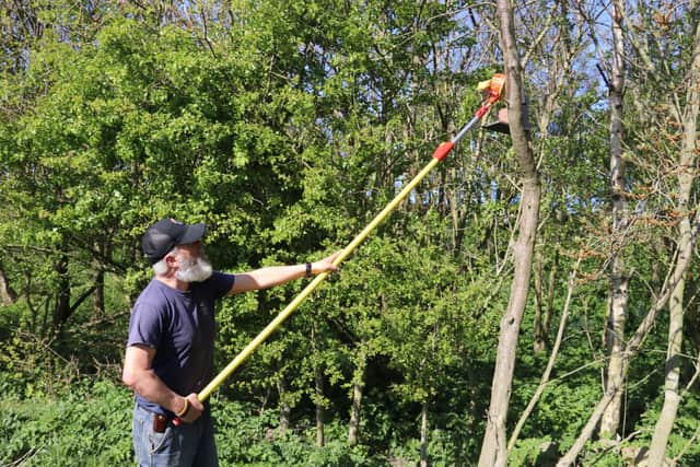 Anthony Johnston, dubbed the Lone Ranger by Northumberland Wildlife Trust staff, restocking the squirrel feeders.