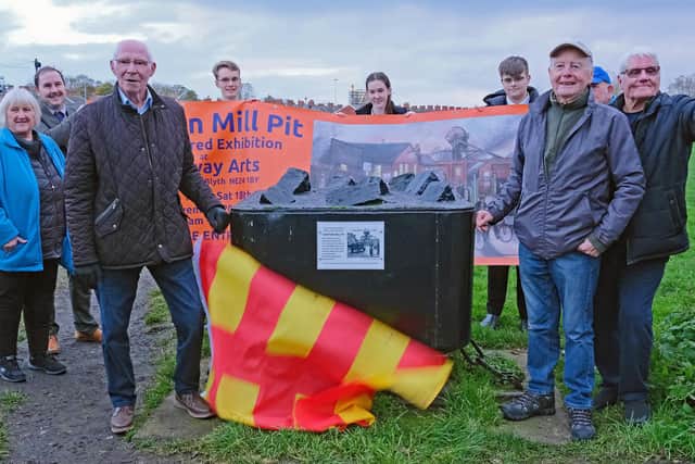 Former miners Danny Winter, Bill Godfrey, and Bobby Bryson unveil a new plaque on the Crofton Mill Pit mine tub ahead of the exhibition. (Photo by Alan and Susan Devlin)