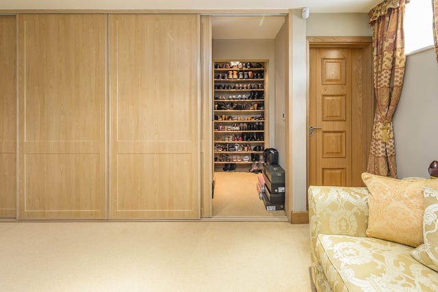There's plenty of space for shoes with this walk-in wardrobe.
