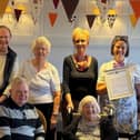 Residents at the care home with Emma Newlands (standing second right) and Fran Richardson holding the Earl's letter.