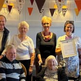 Residents at the care home with Emma Newlands (standing second right) and Fran Richardson holding the Earl's letter.