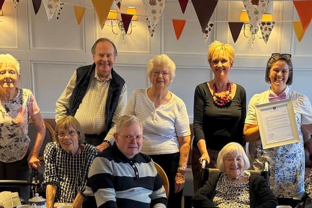 Residents at the care home with Emma Newlands (standing second right) and Fran Richardson holding the Earl's letter.