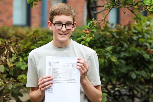 A delighted Joe Ross with his GCSE results slip.