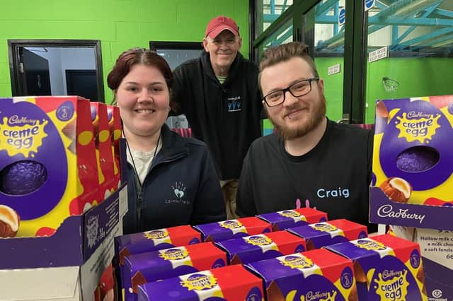 Pictured at the donation of Easter eggs to Calmer Therapy, from left, are Victoria Swan, Tom Stewart and Craig Wilson.