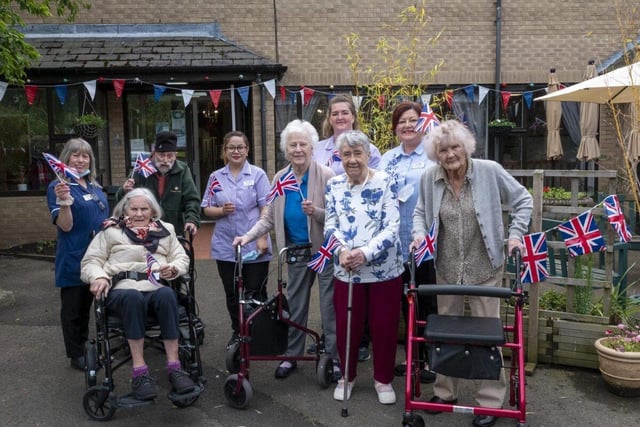 Residents of Abbeyfield House waving their union flags as they looked ahead to inviting friends and family around to their coffee afternoon.