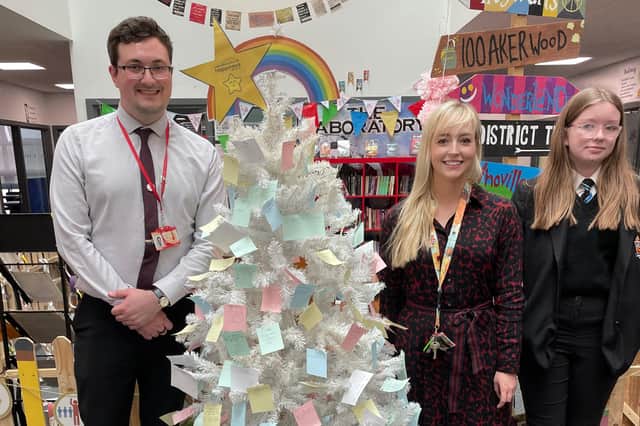 International Coordinators, James Pearson and Elizabeth McNally with a student from Duke’s Secondary School next to the Gratitude Tree.