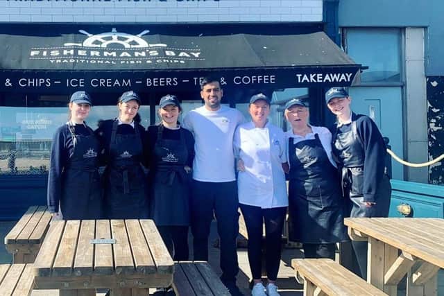 The staff of Fisherman's Bay outside the restaurant on the Whitley Bay seafront. Manager Steven Dhillon says the team's customer service is a key reason for their success so far.