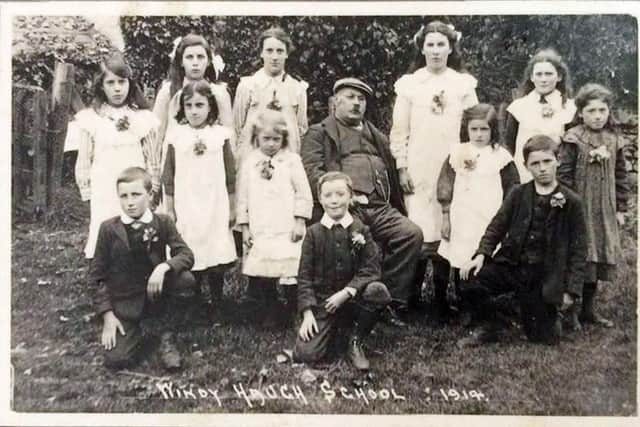 Andrew Richardson Blythe with his last class of pupils at Windyhaugh School on the event of his retirement back to Yetholm in August 1919.