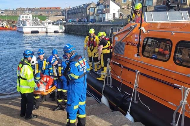 A woman is stretchered off Seahouses lifeboat after her fall on the Farne Islands. Picture: Seahouses RNLI