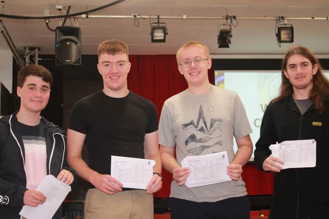 Delighted pupils with their GCSE result slips.