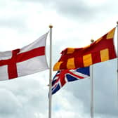 The English flag with the Union Jack and the Northumberland flag at the English/Scottish border on the A1.