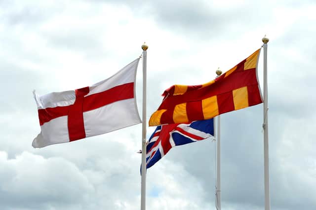 The English flag with the Union Jack and the Northumberland flag at the English/Scottish border on the A1.