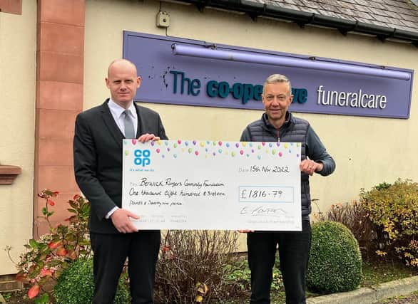 Edward Foxton presents a cheque to Berwick Rangers Community Foundation trustee, Stuart Birkett.