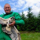 Martin Davison, Forestry England ornithologist, with an osprey chick ringed in Kielder Forest.