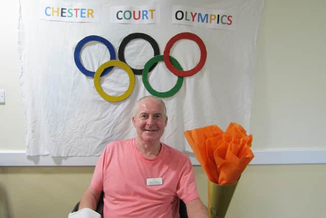 A Chester Court resident takes part in the opening ceremony for the home's Olympics.