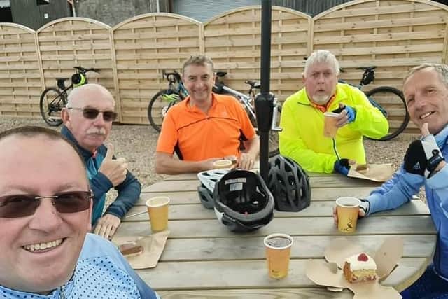 The five men who will be doing a 58-mile fundraising bike ride on August 28 take a break during a training ride.