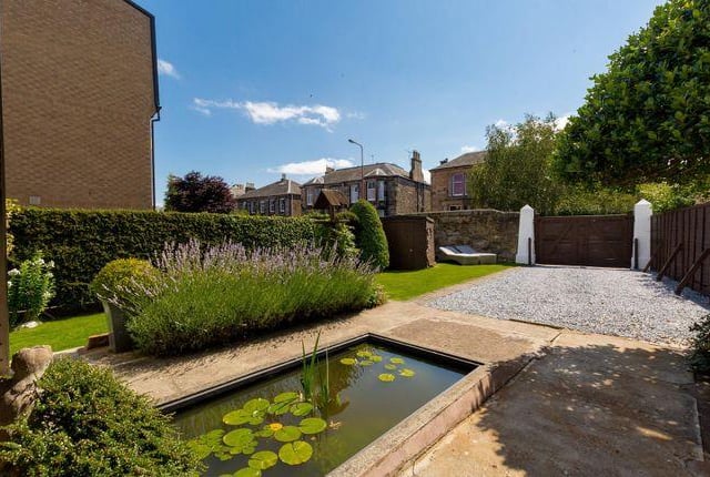 To the rear of the property, there’s a well-designed, pretty garden