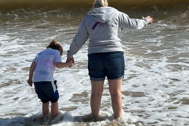 Little girl plodging in the sea at ARC Adoption Beach Celebration for families