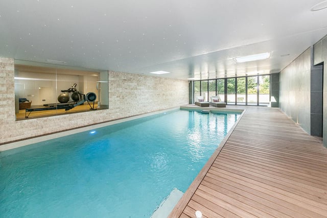 Tempered glass panelling opens into the swimming pool with changing room/shower room and steam room. Yacht style teak flooring wraps around two sides of the pool with a reclining area to the rear.