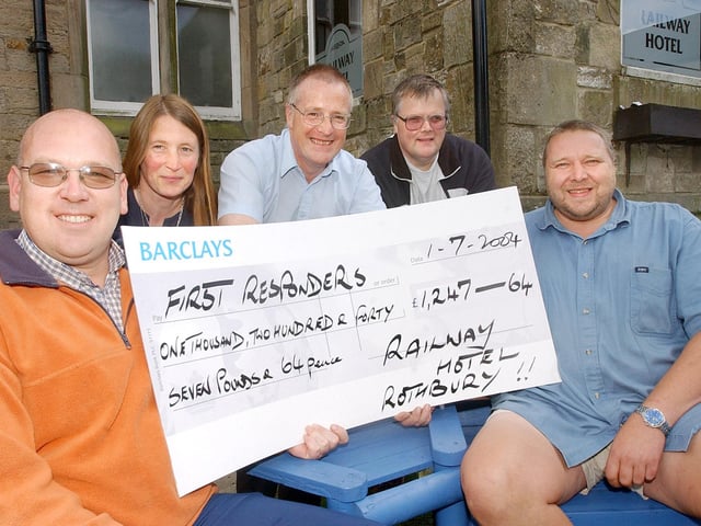 NIGEL TURNER AND ANGUS HUTTON FROM THE RAILWAY HOTEL IN ROTHBURY WITH PROCEEDS OF SPONSORED HEAD SHAVE.
