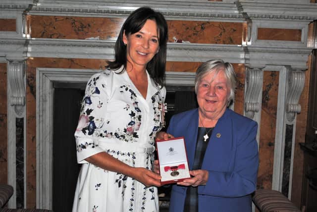 Rhona Dunn receives her British Empire Medal from Her Grace, the Duchess of Northumberland.