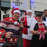 From left, Paul Martin, Steffen Peddie as Santa, Sharon Carr from The Harbour View with Fish and Chip, and Waseem Mir. (Photo by Highlights PR)