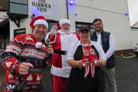 From left, Paul Martin, Steffen Peddie as Santa, Sharon Carr from The Harbour View with Fish and Chip, and Waseem Mir. (Photo by Highlights PR)