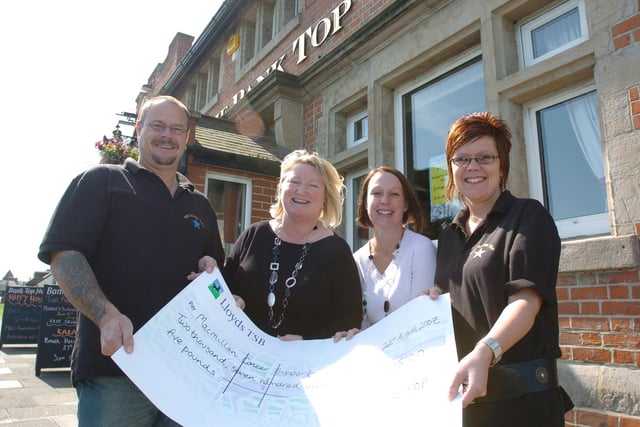 Tracy and Brian Groom, of the Bank Top pub, present a cheque for £2,705 to Macmillan fundraisers Michelle Muir and Jane Curry.
