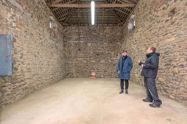 Rebecca Wilson talks to Chris Jones from Northumberland National Park inside one of the historial barns restored at Ingram Valley Farm.