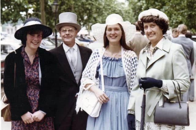 John with Nancy and their two daughters at Buckingham Palace in 1980.
