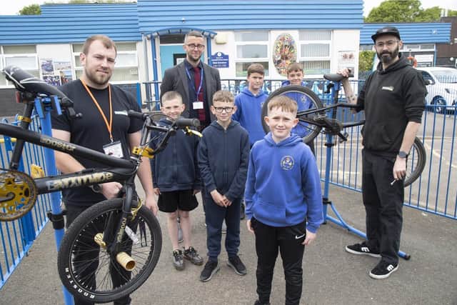Jack Swain, left, Joel Routledge and Ryan Collins, right, with a group of Beaconhill Primary School pupils. Picture by Steve Brock.