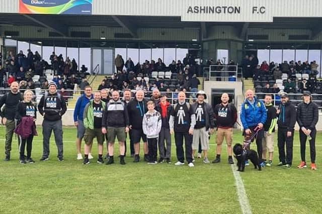 The fundraising walkers on the pitch at Ashington FC.